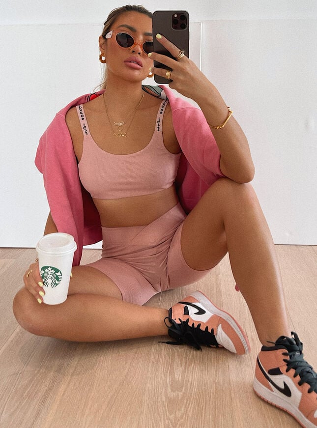 woman wearing pink bralette and cycling shorts set
