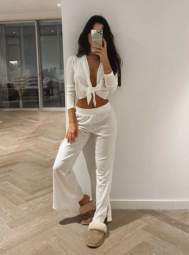 woman wearing white top and wide leg pants